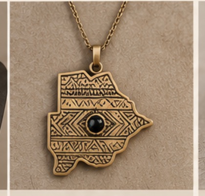 Brass pendant in the shape of Botswana with engraved pattern and black stone